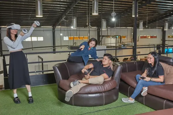 Team members discussing work in a Clark office lounge in the Philippines